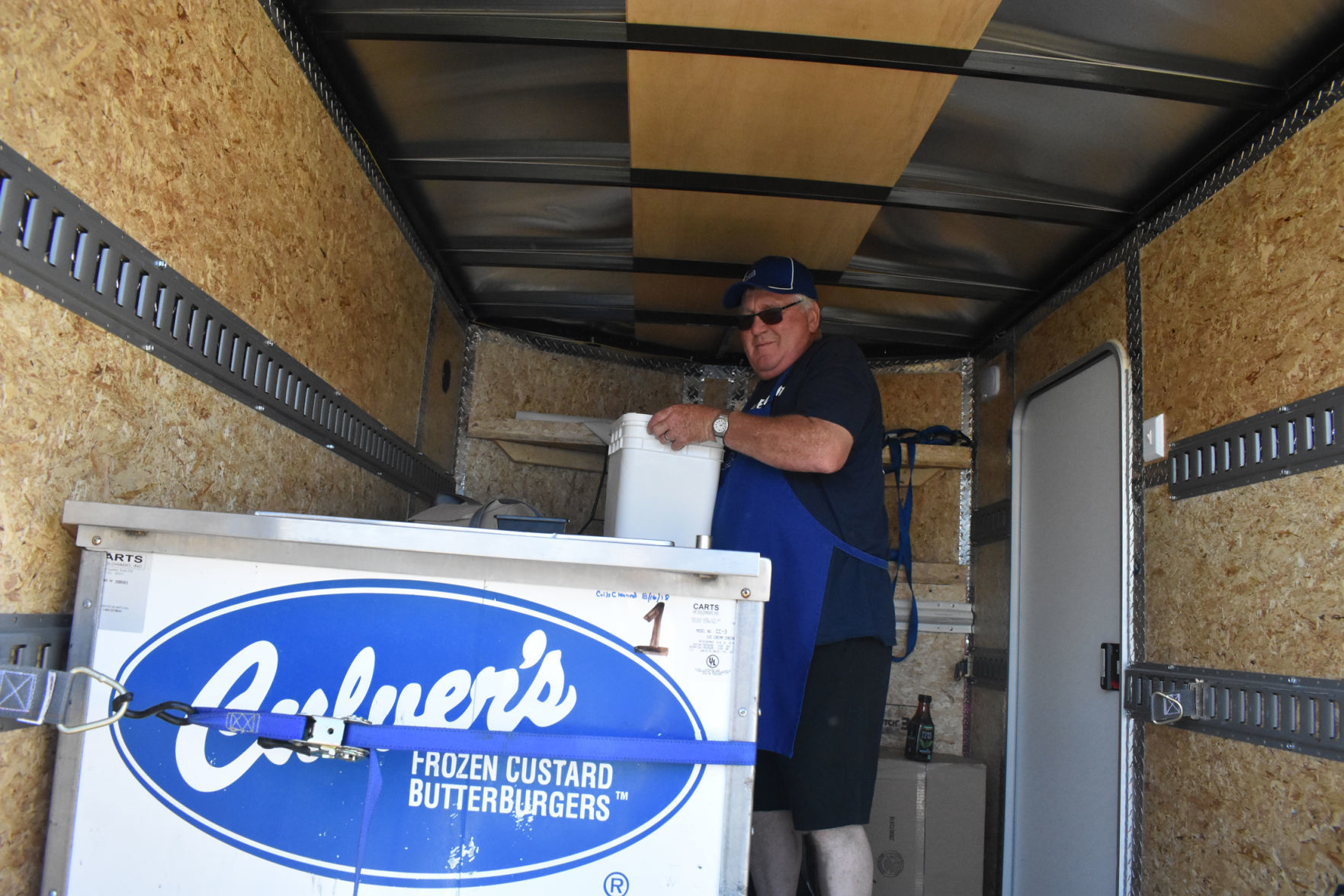 John Evert carries bucket of custard